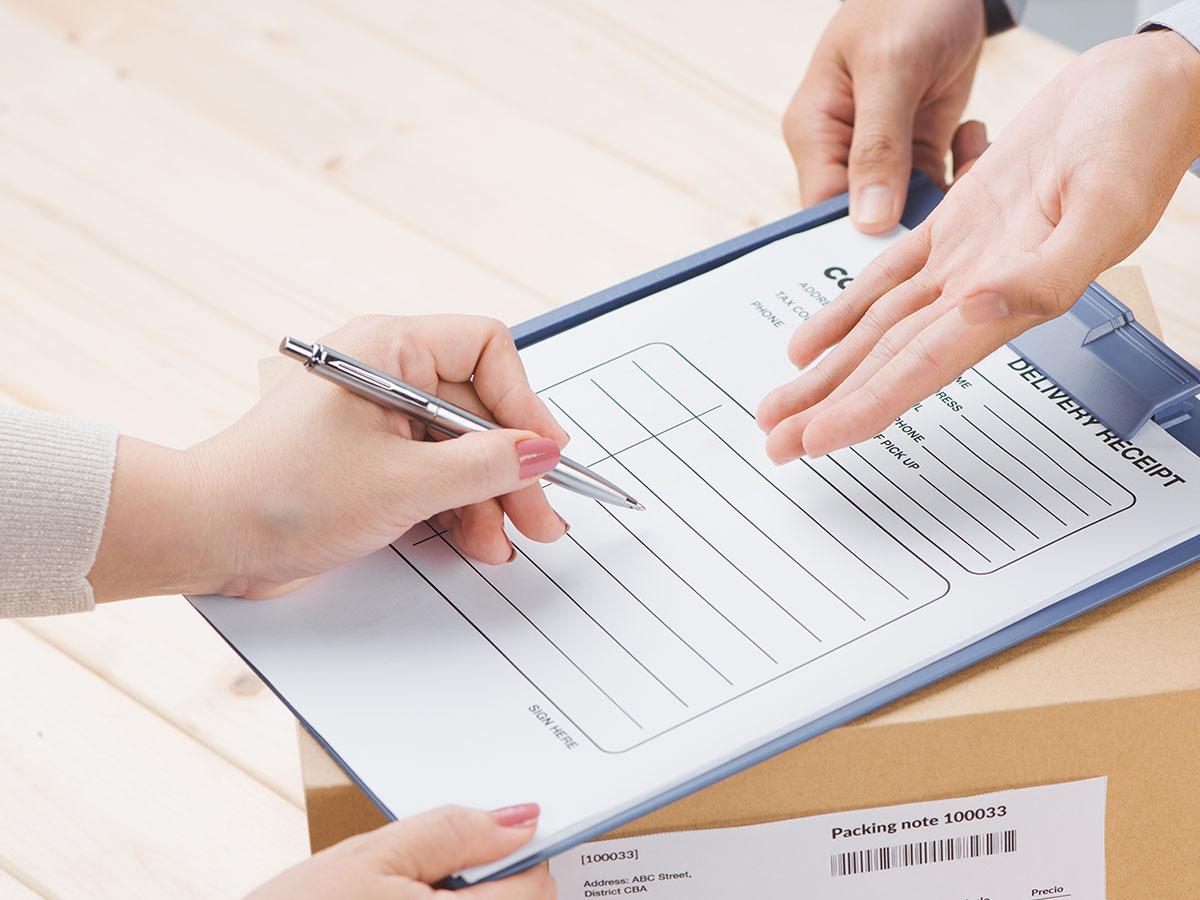 Woman signing for a package.